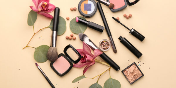 Decorative Cosmetics And Brushes Of Professional Makeup Artist On Color Background
